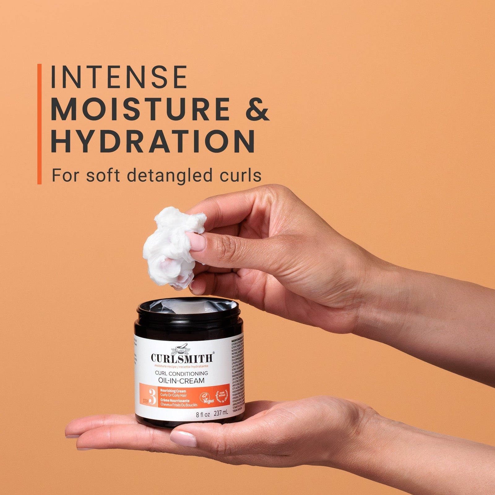 Person holding a jar of Curlsmith hair cream with a brown background