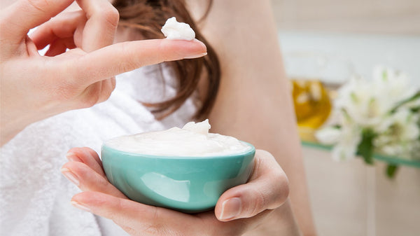 Woman holding a bowl of cream