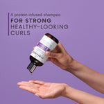 Hand holding a protein-infused shampoo bottle with text on a purple background