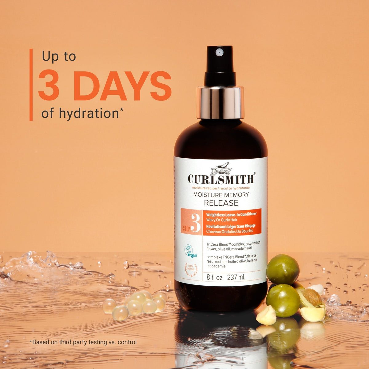 Curlsmitth hair care product with grapes on a wooden surface and water droplets.